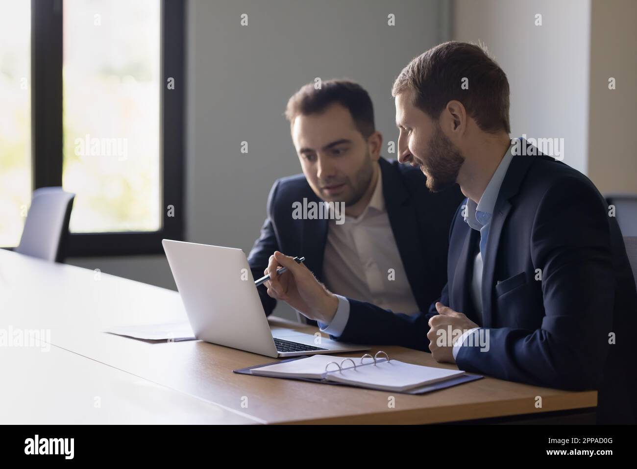 Two positive business colleagues men testing new professional application Stock Photo