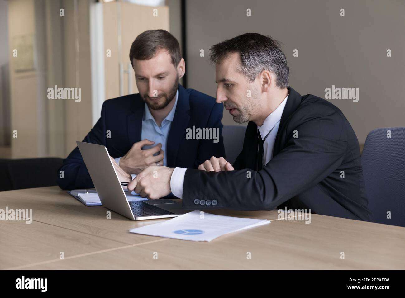 Worried business executive and assistant watching content on Internet ...