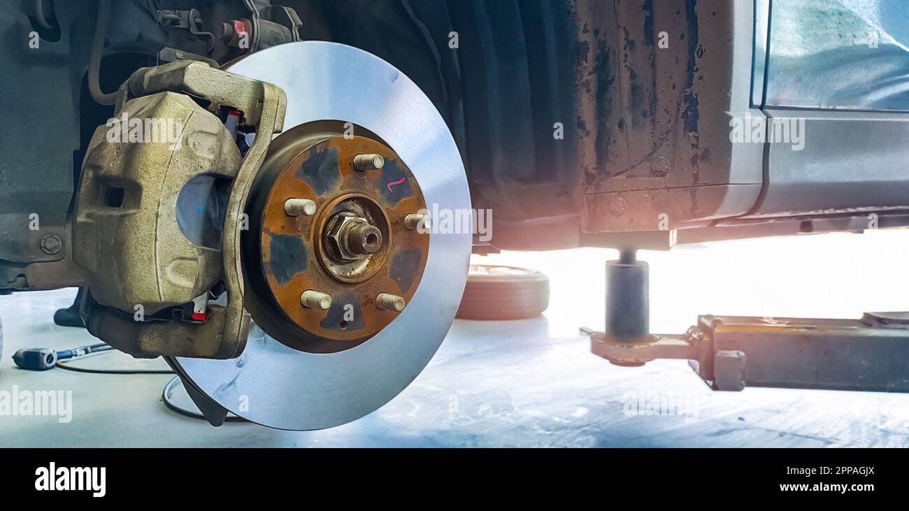 Car disc brake system. Car suspension in process of new tire