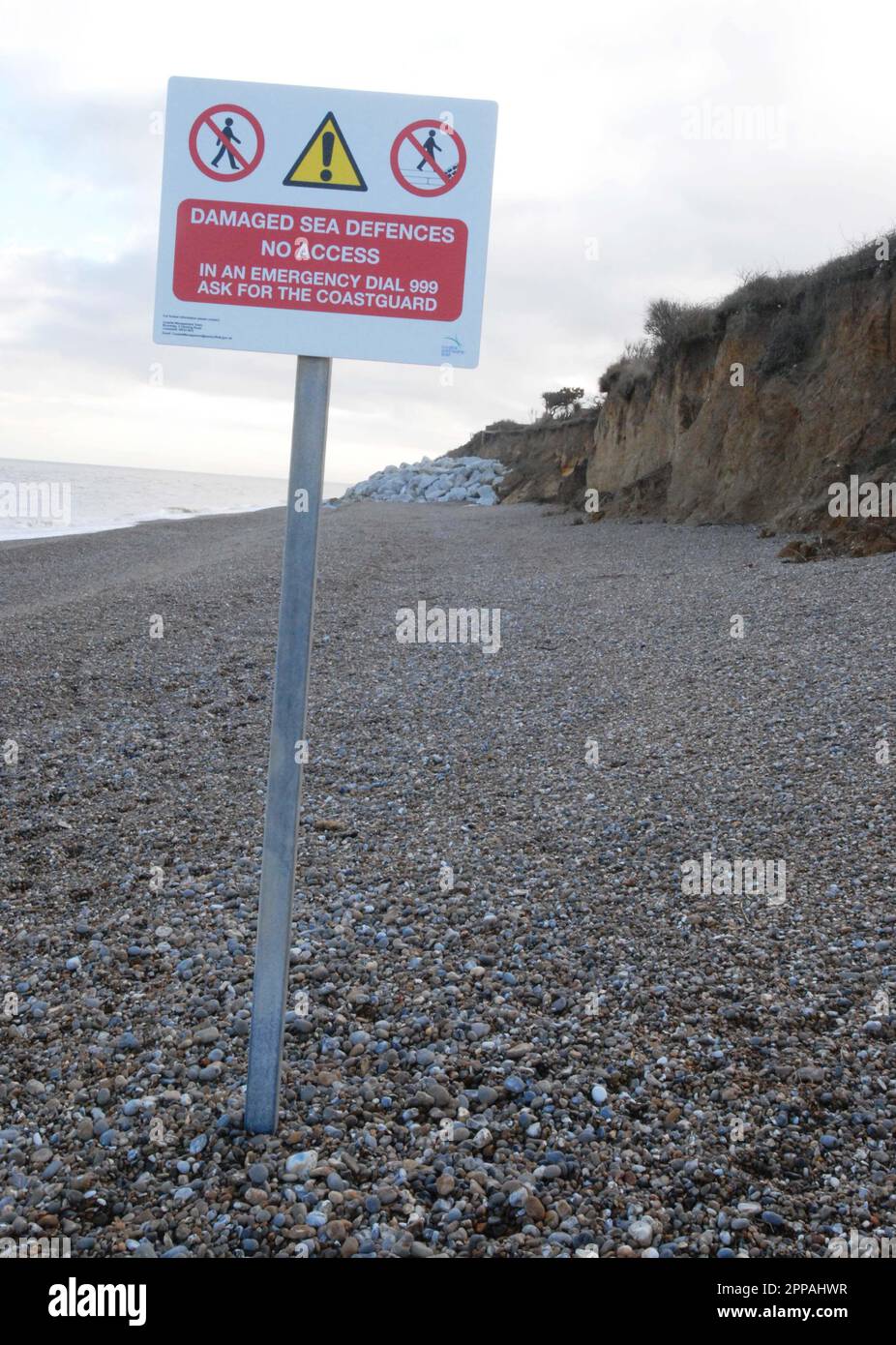 Sign warning Damaged Sea Defence No Access, with eroded cliff & 35 ...