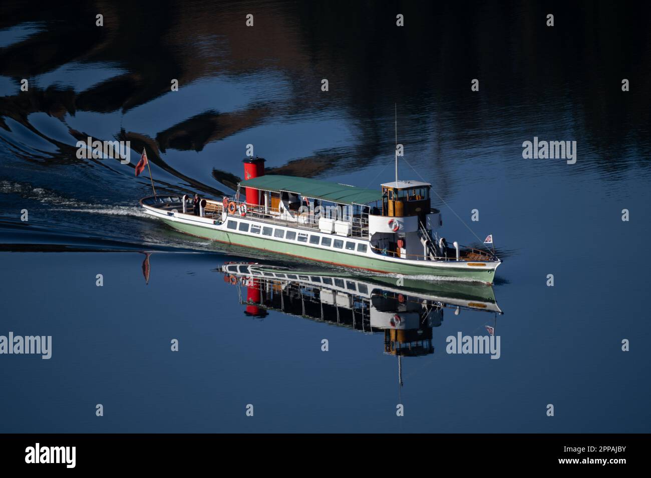 Ullswater Steamers 'Raven' sailing across Ullswater on a crisp spring morning Stock Photo