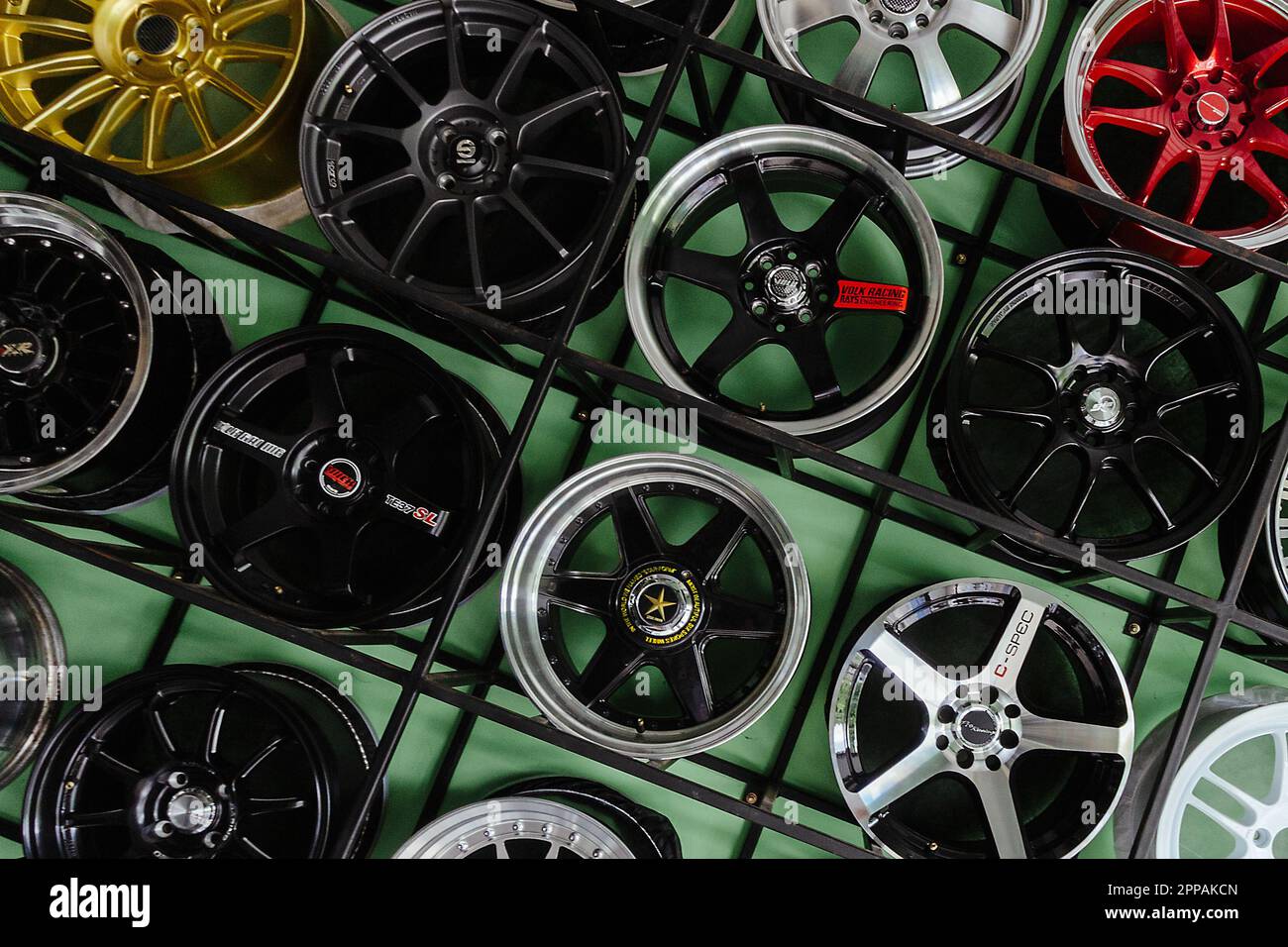 Alloy wheels on showroom rack in tire warehouse Stock Photo - Alamy