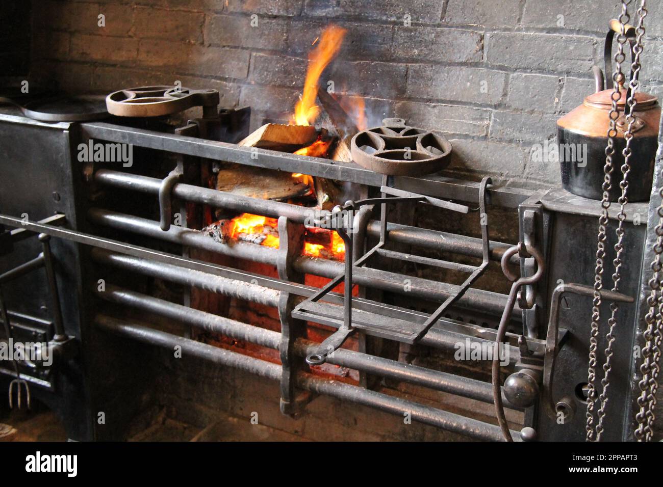 A Wood Fuelled Vintage Cooking Range with Fire. Stock Photo