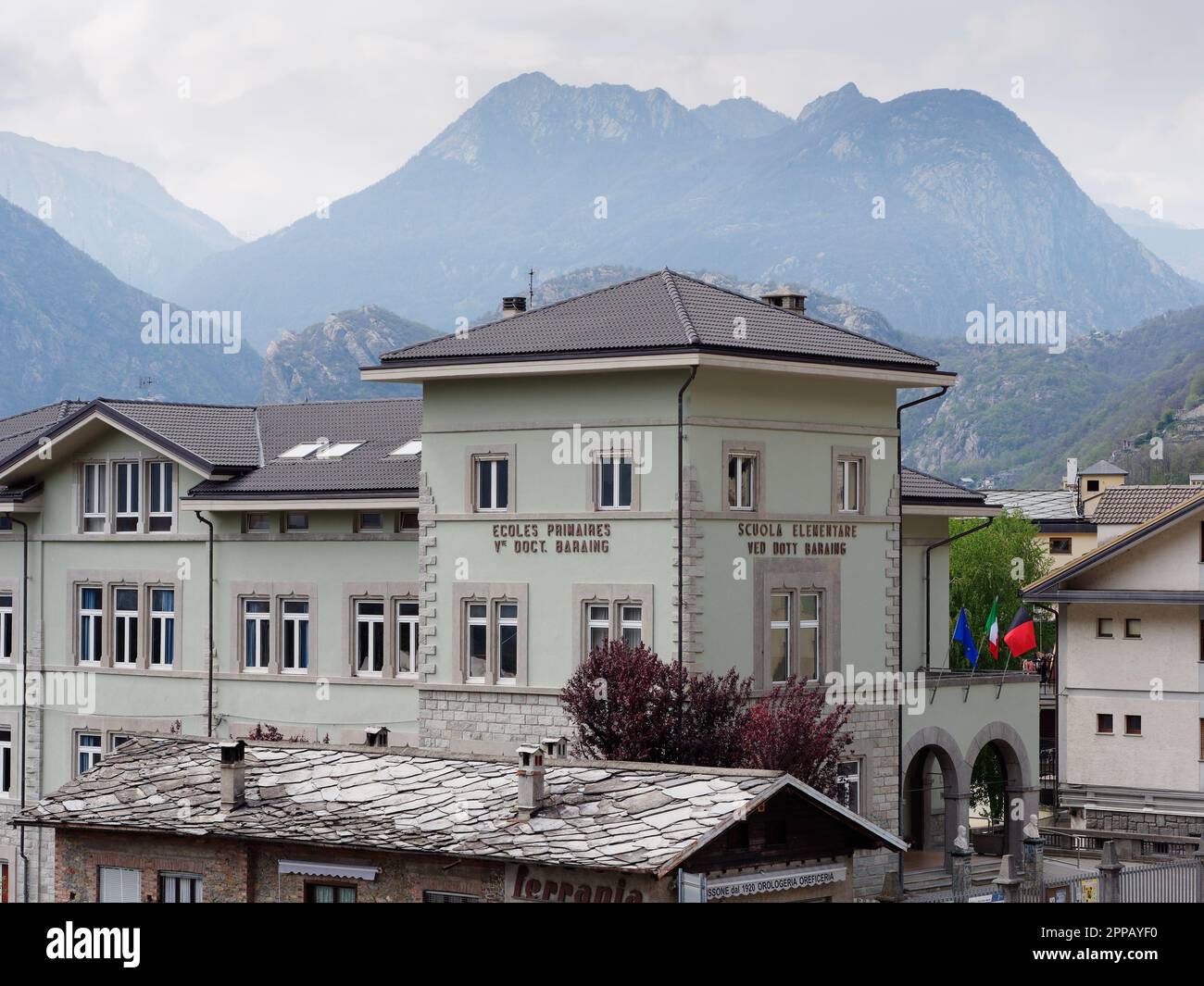TLarge elementary school in the town of Pont-Saint-Martin, Aosta Valley, NW Italy. Valley and mountains behind Stock Photo