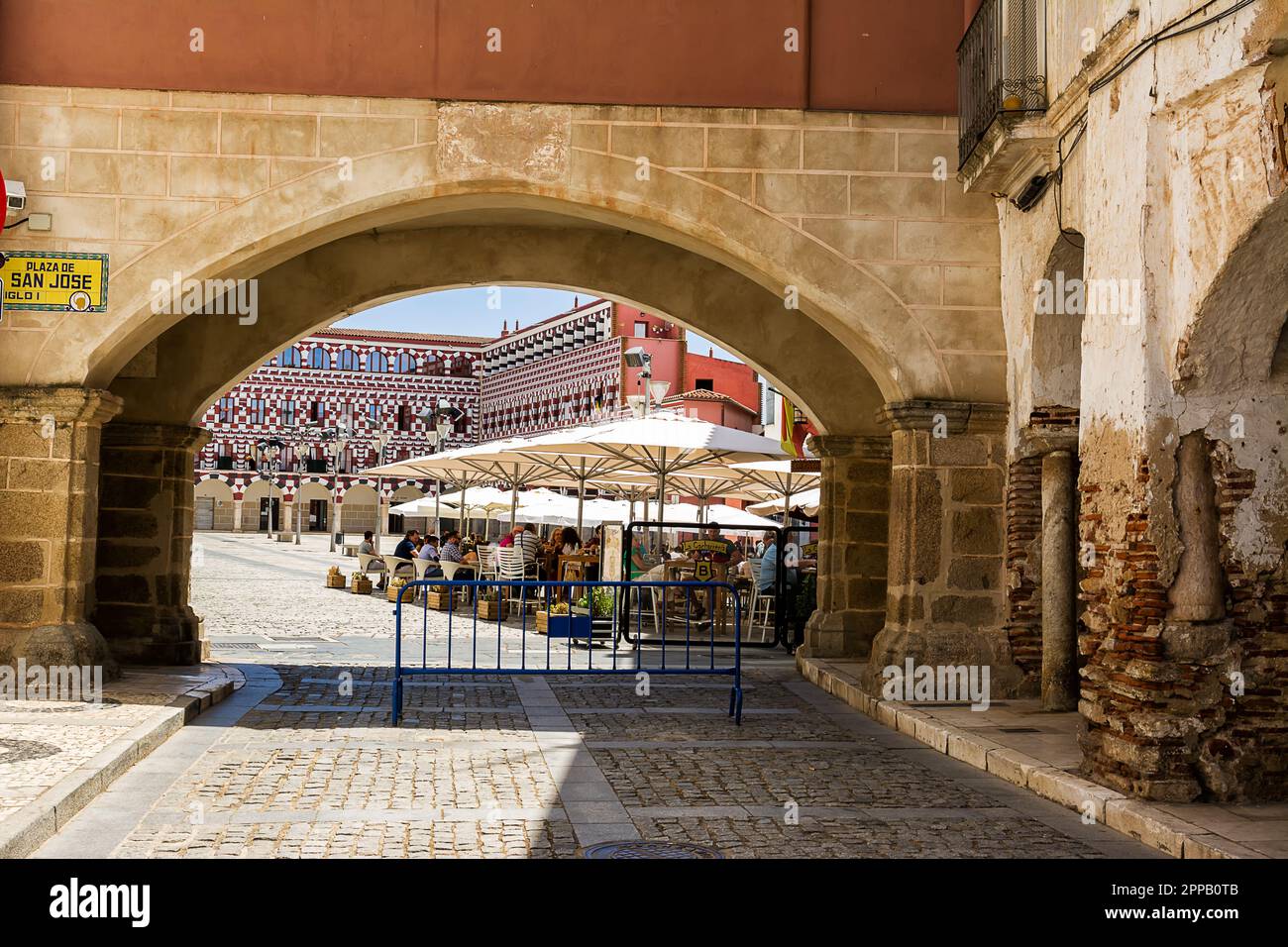 Badajoz, Spain - 24 June 2022: Facades of the colorful buildings and houses in the Alta Square in Badajoz seen from under the arch of the Peso (Spain) Stock Photo