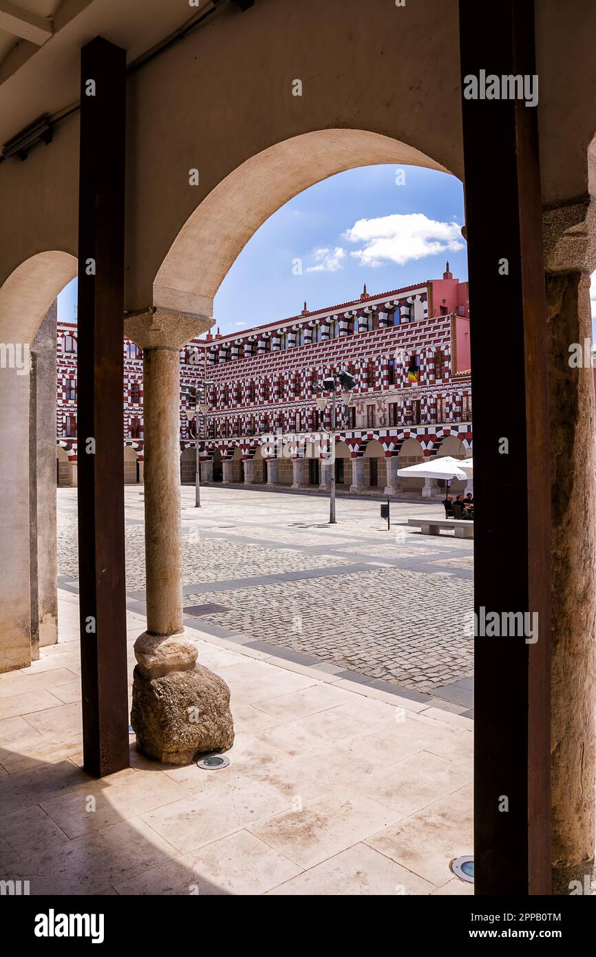 Badajoz, Spain - 24 June 2022: Facades of the colorful buildings and houses in the Alta Square in Badajoz seen from under an arch (Spain) Stock Photo
