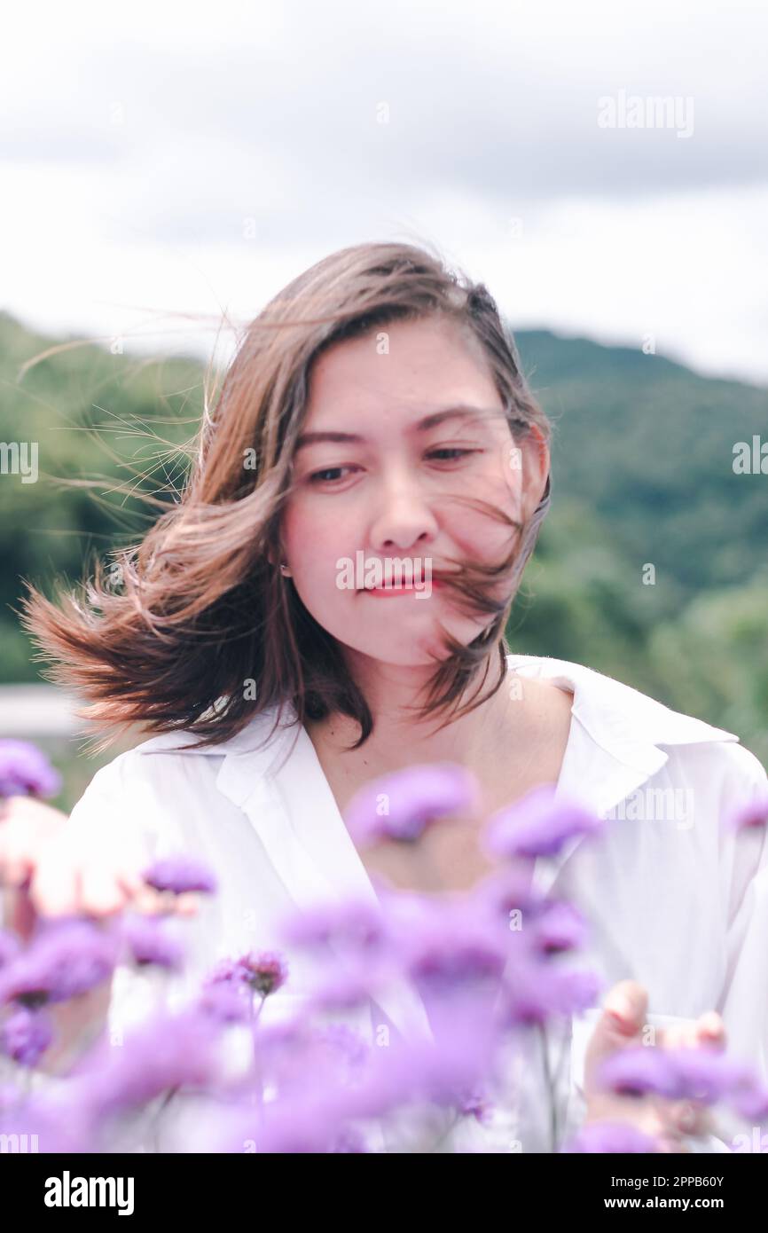 Women in the Verbena field are blooming and beautiful in the rainy
