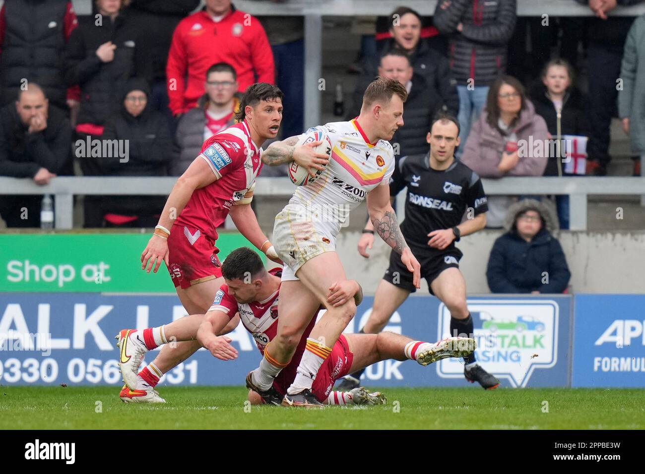 Tom Johnstone 24 of Catalans Dragons breaks a tackle during the