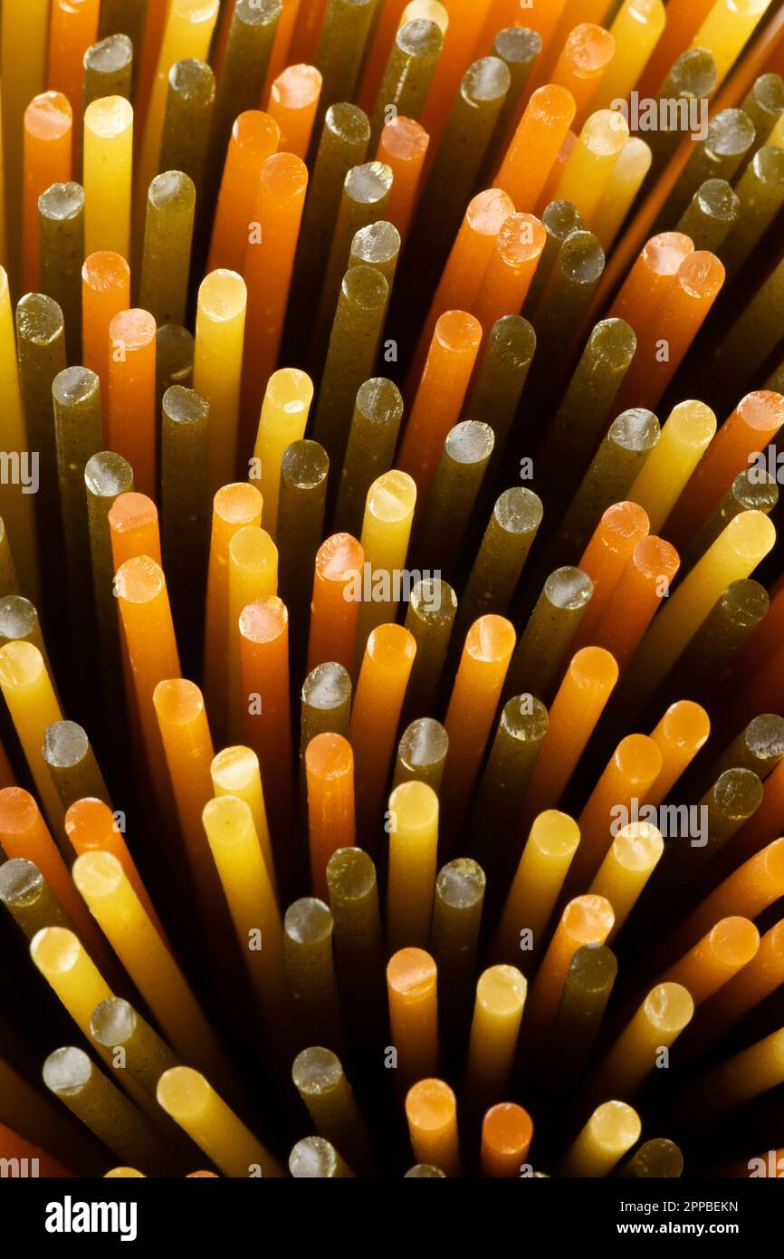 Spaghetti tricolore seen from above close up full frame as background ...