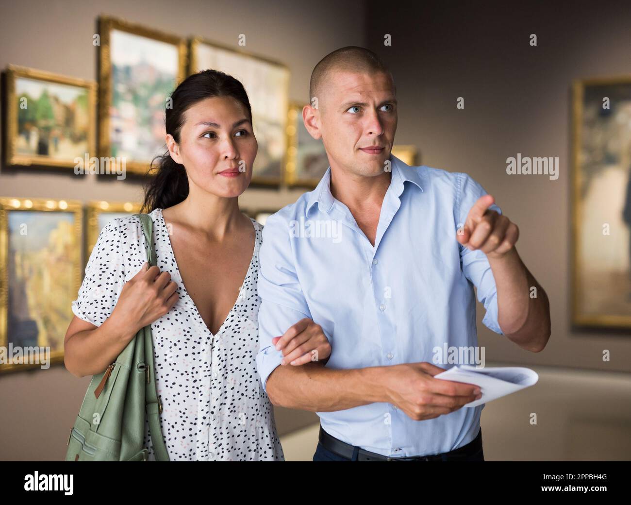 Man and woman in gallery Stock Photo - Alamy