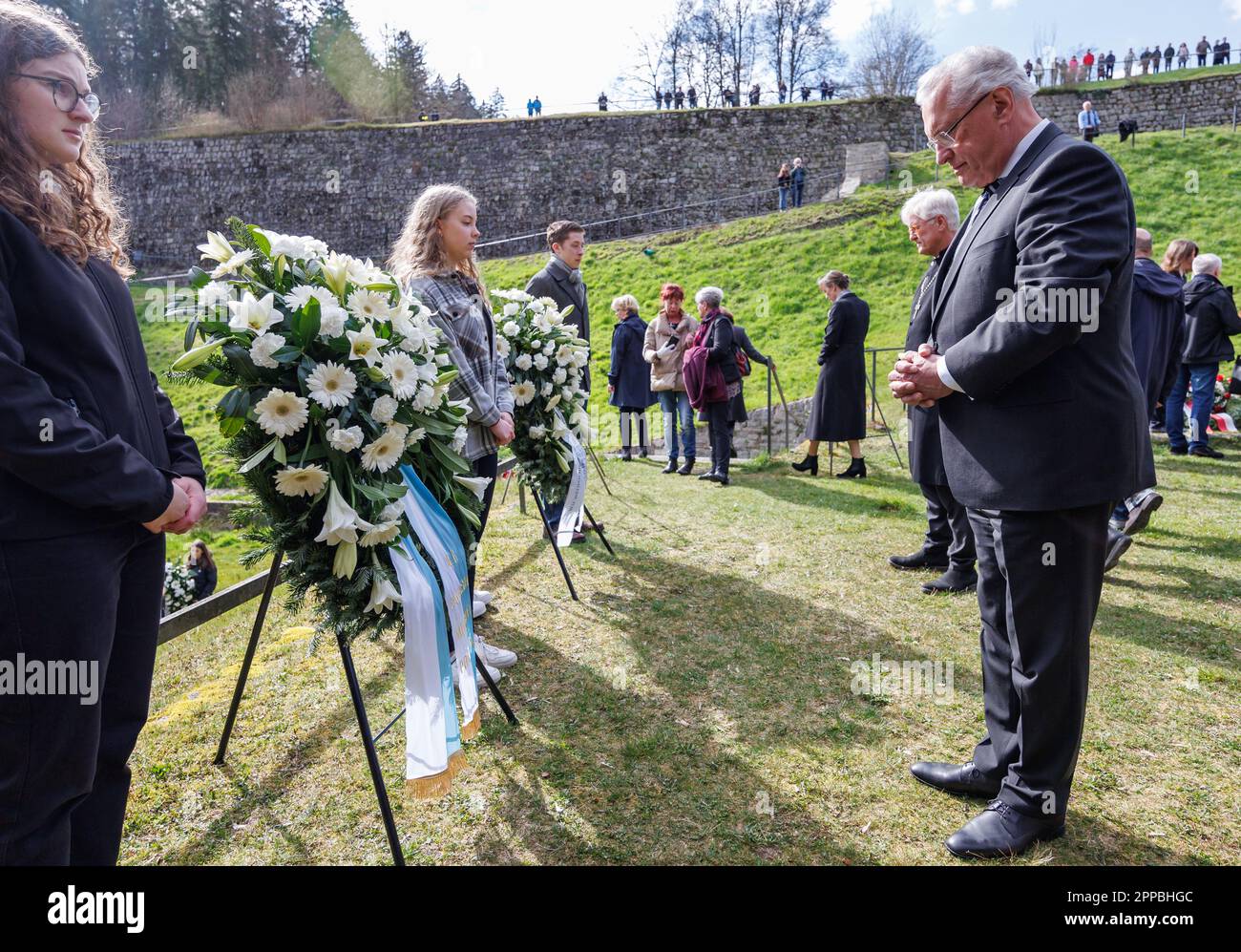 23 April 2023, Bavaria, Flossenbürg: Joachim Herrmann (r, CSU), Minister of the Interior of Bavaria, stands at a wreath in the so-called 'Valley of Death' in memory of the victims of the concentration camp during the commemoration of the 78th anniversary of its liberation. Next to him is Heinrich Bedford-Strohm, regional bishop of the Evangelical Lutheran Church in Bavaria. Flossenbürg concentration camp had been liberated by the U.S. Army on April 23, 1945. Of about 100,000 people imprisoned there or in the subcamps, around 30,000 had died. Photo: Daniel Karmann/dpa Stock Photo