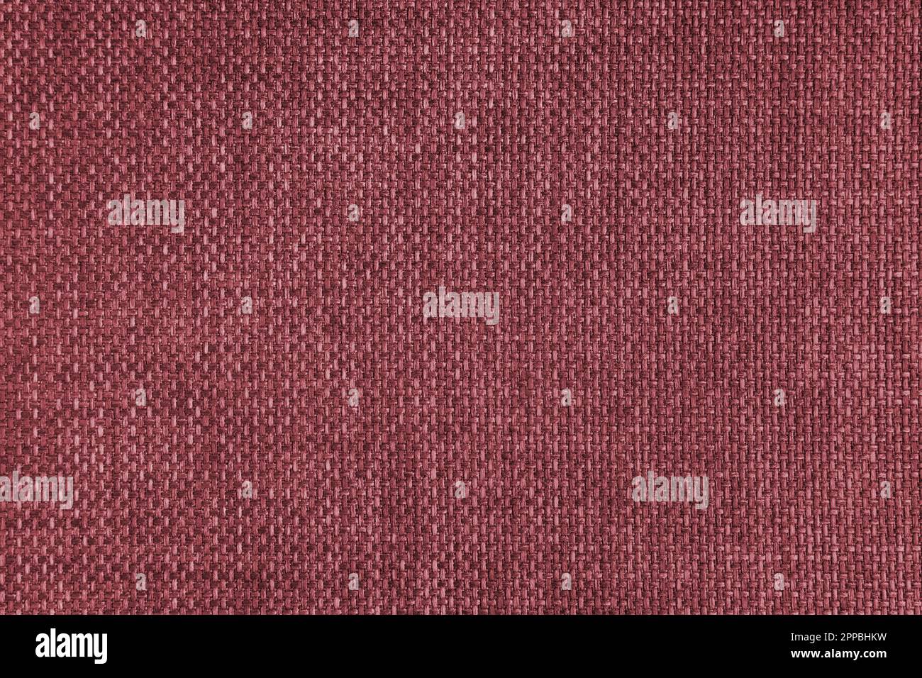Jacquard woven upholstery, red coarse fabric texture. Textile