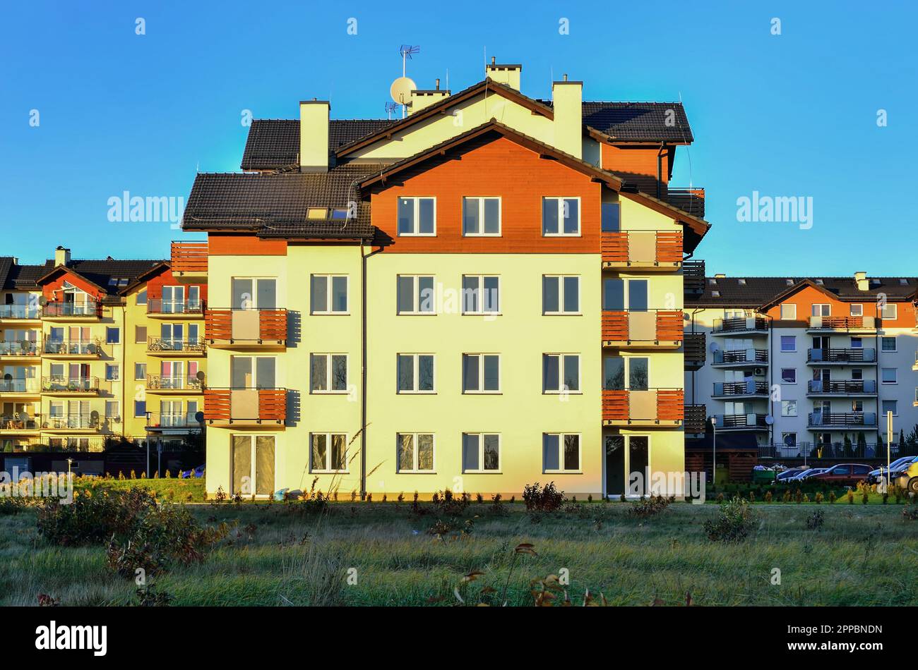 New housing estates in Poland. Public view of newly built block of flats in green area. Photo taken in Tychy, Poland. Stock Photo