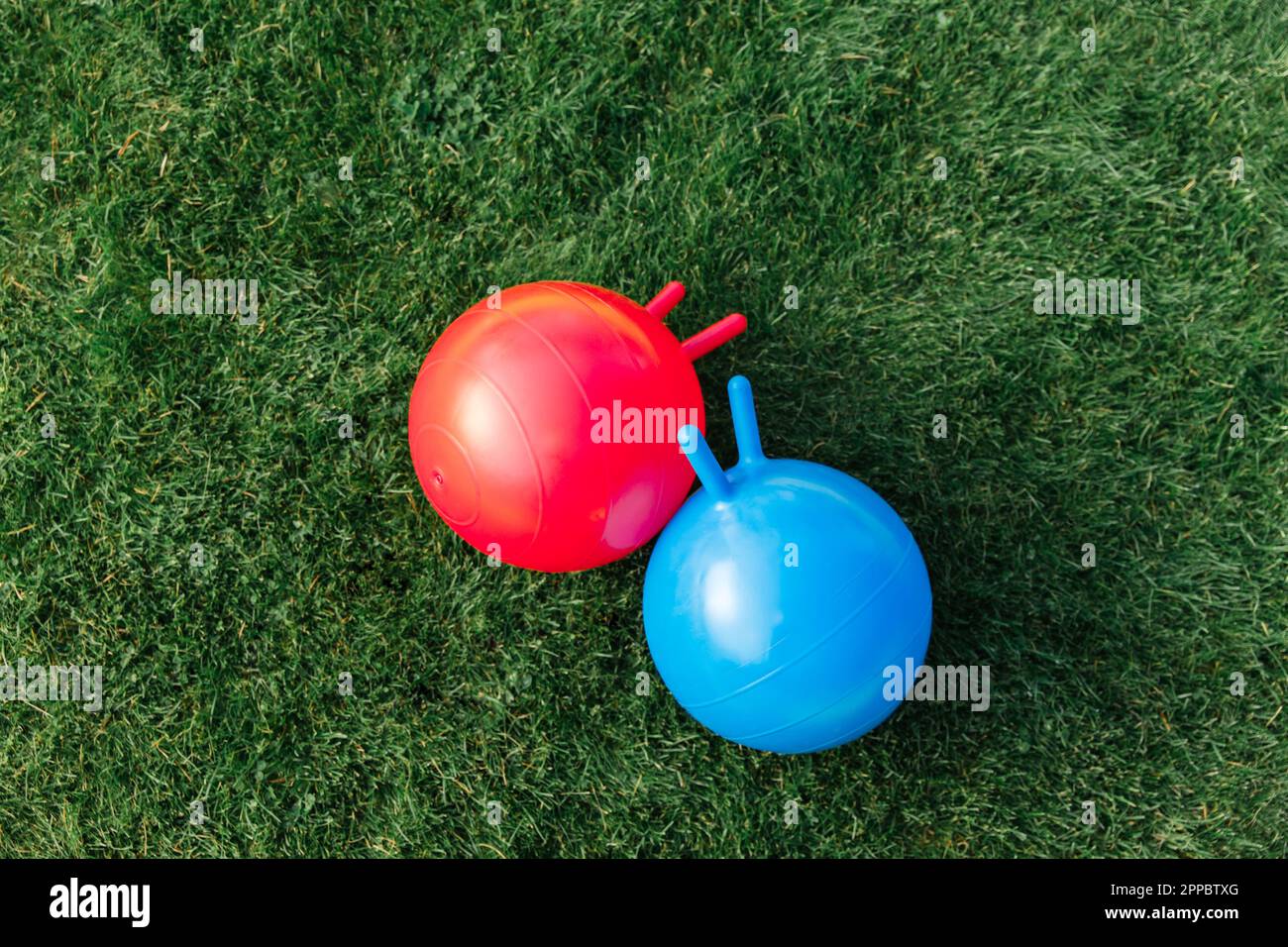 two bouncing balls or hoppers on grass Stock Photo Alamy