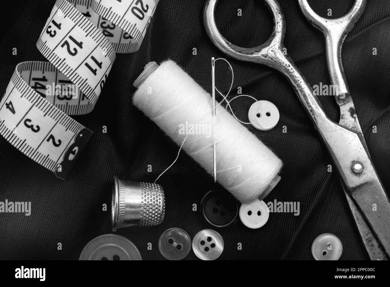 Old vintage sewing accessories. Needle with threads. Scissors