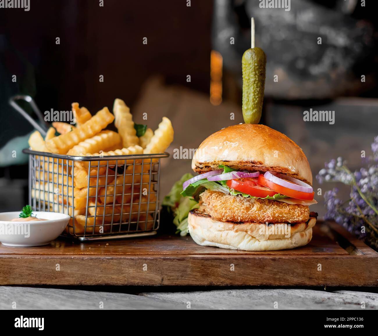 Crispy Fried Fish Burger served with fries and salad decorated with