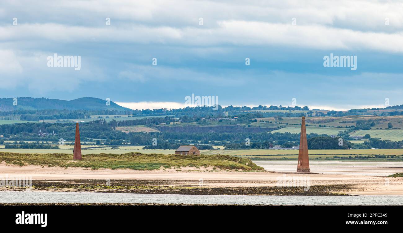 Navigational sea markers on sandbank in estuary, Holy Island of Lindisfarne, Northumberland, England, UK Stock Photo