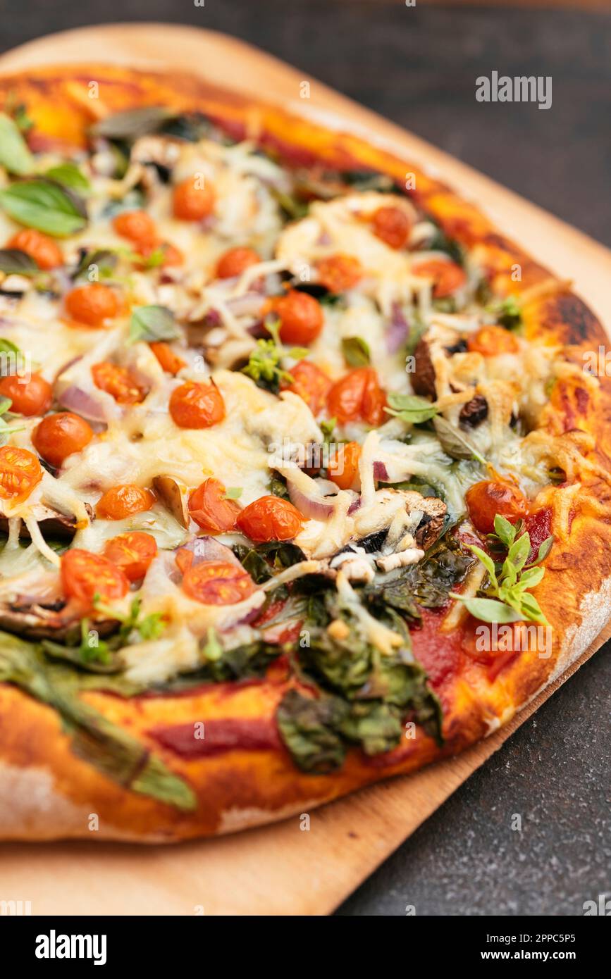 Home made vegan spinach mushroom pizza. Stock Photo