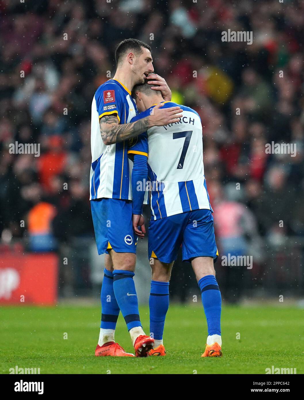 Brighton and Hove Albion's Lewis Dunk comforts Solly March after missing his penalty in the shoot-out during the Emirates FA Cup semi-final match at Wembley Stadium, London. Picture date: Sunday April 23, 2023. Stock Photo