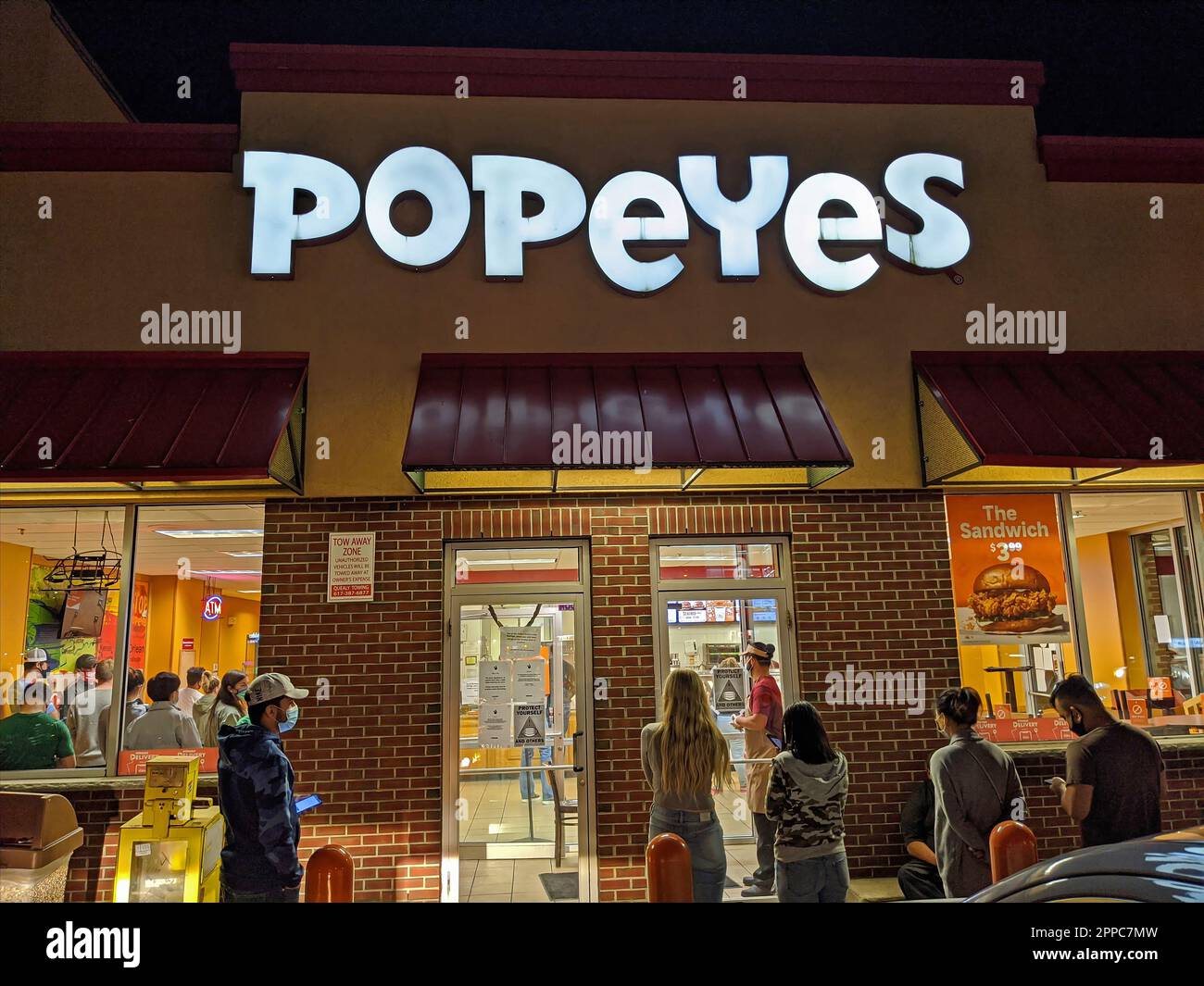 Popeyes chicken restaurant, people waiting in line to order, night time ...