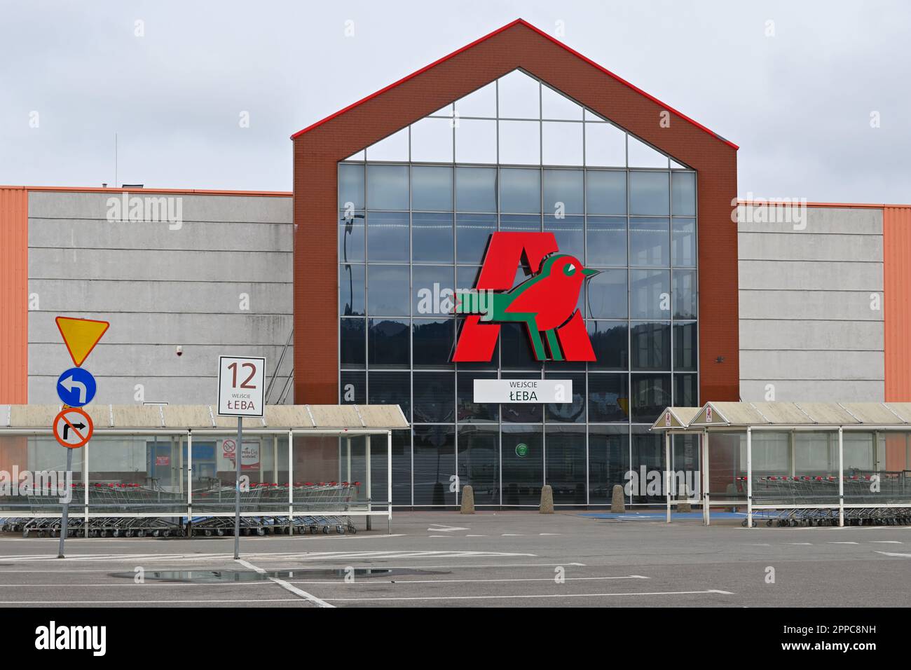 Rumia, Poland - April 16, 2023: Auchan logo on the facade of the store. Auchan is a French hypermarket chain Stock Photo