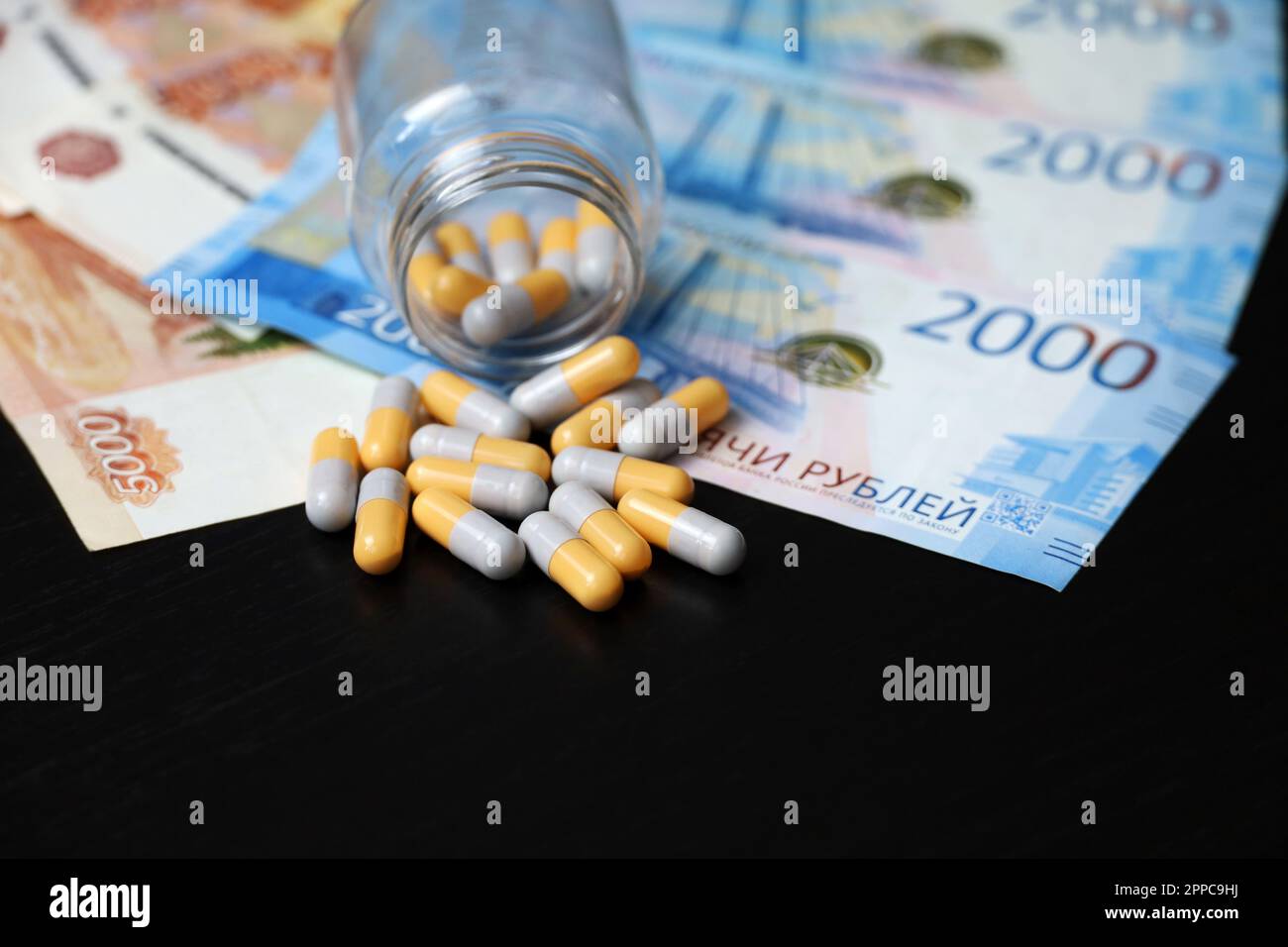 Pills on banknotes of the russian rubles. Medication in capsules, concept of pharmaceutical business, rise in price of medicines, healthcare in Russia Stock Photo