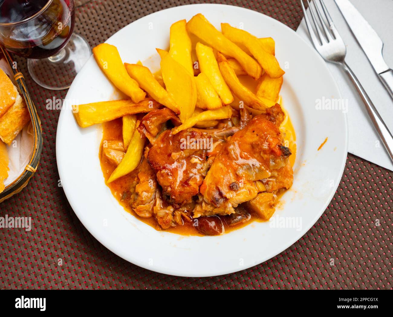 Braised rabbit served with potato garnish Stock Photo