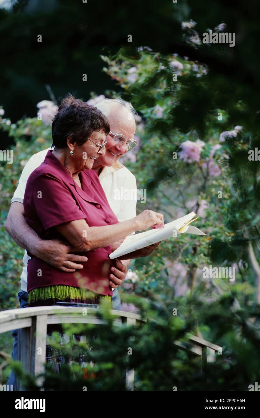Senior couple enjoy quality time in your garden while the women's Skechers a plant Stock Photo
