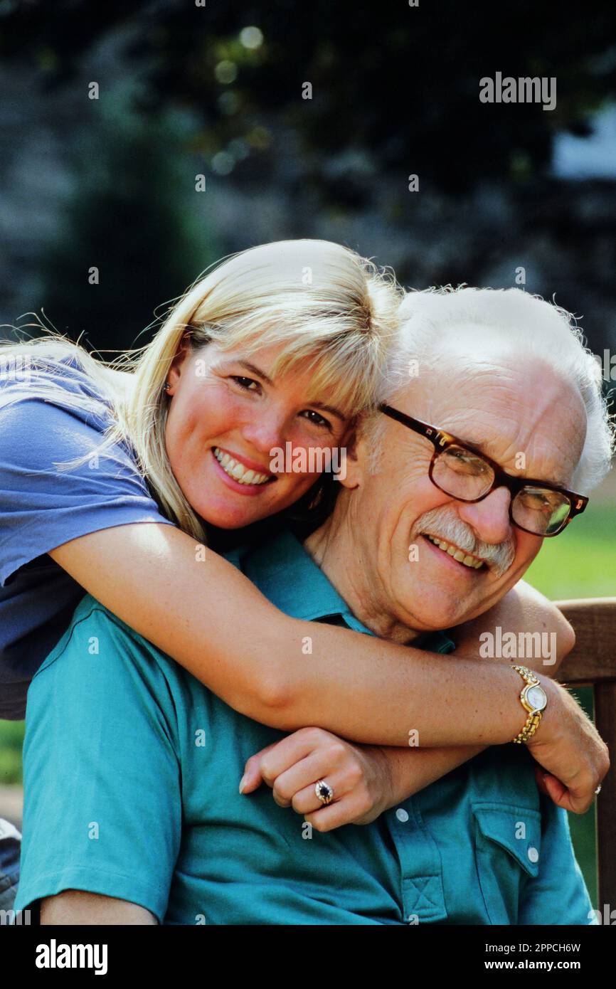Hugged Portrait of a Caucasian senior man being hugged by his adult daughter ...