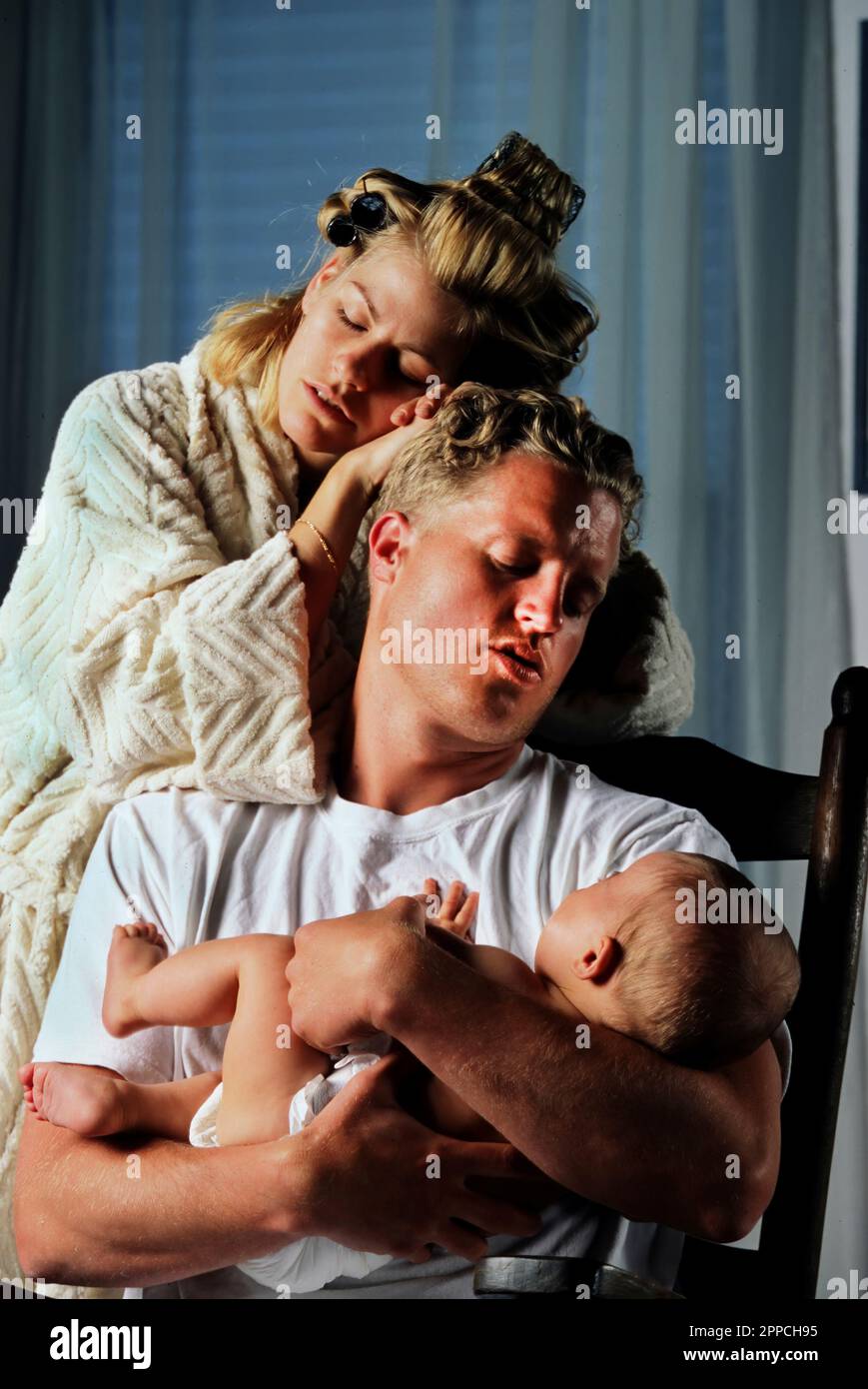Exhausted sleepless mother and father with crying newborn baby Stock Photo