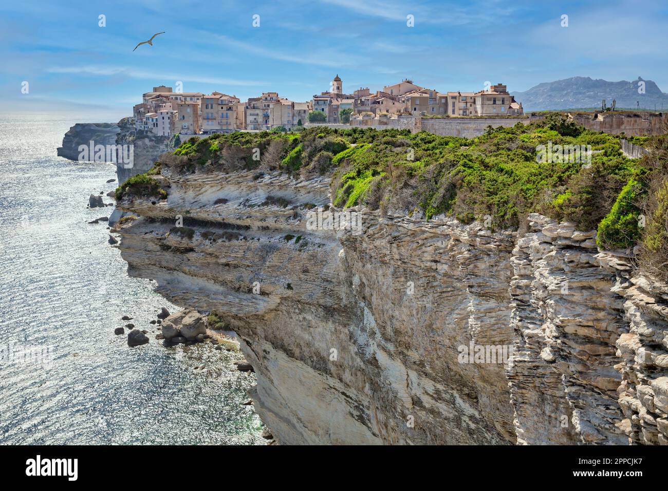 Bonifacio is situated on the cliffs of a limestone peninsula sculpted and eroded by the sea,with buildings overhanging the edge,Corsica island, France Stock Photo