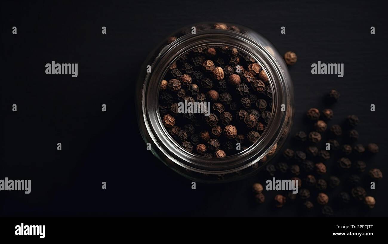 Top view of dry black peppercorns on dark background. Copy space for