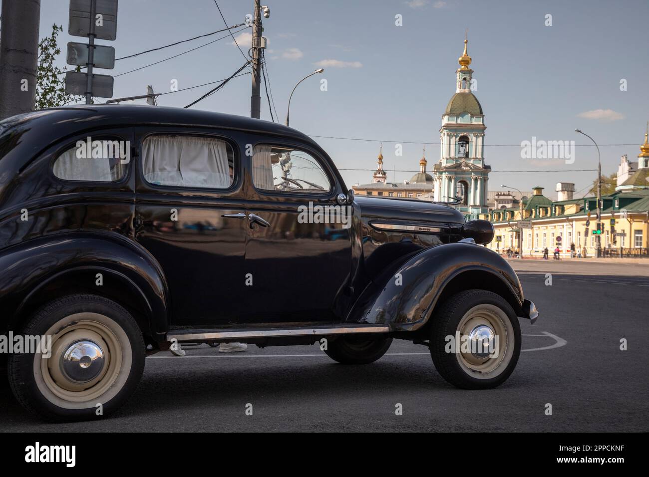 Moscow, Russia. 23rd of April, 2023. A vintage 1940 Chrysler De Soto car stands at the entrance of a high-rise building on Kotelnicheskaya Embankment on Yauzskaya Street in the center of Moscow, Russia Stock Photo