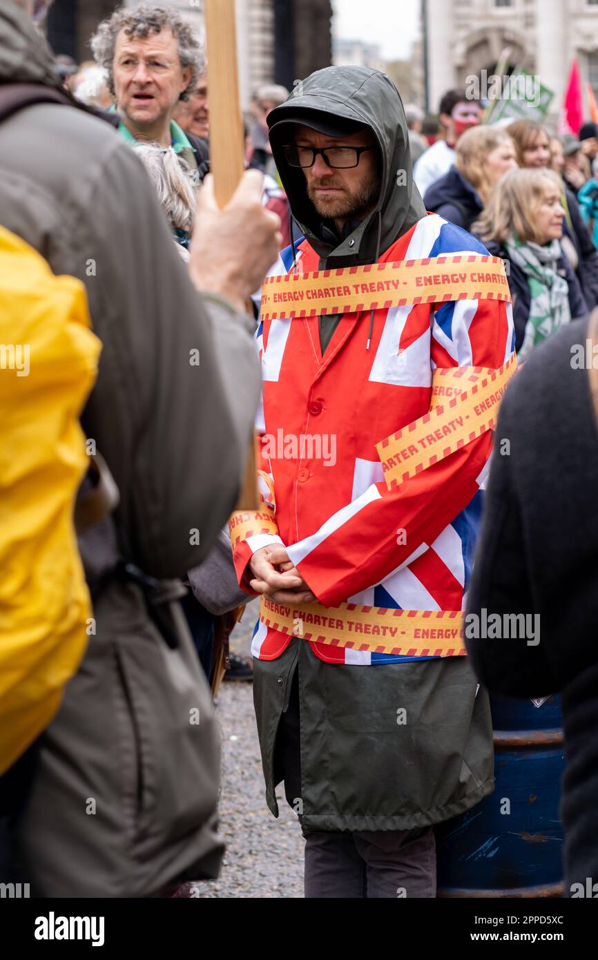 Activist wearing Union Jack jacket tied to Oil Drums outside Department for Business and Trade during 'The Big One' Extinction Rebellion event London. Stock Photo