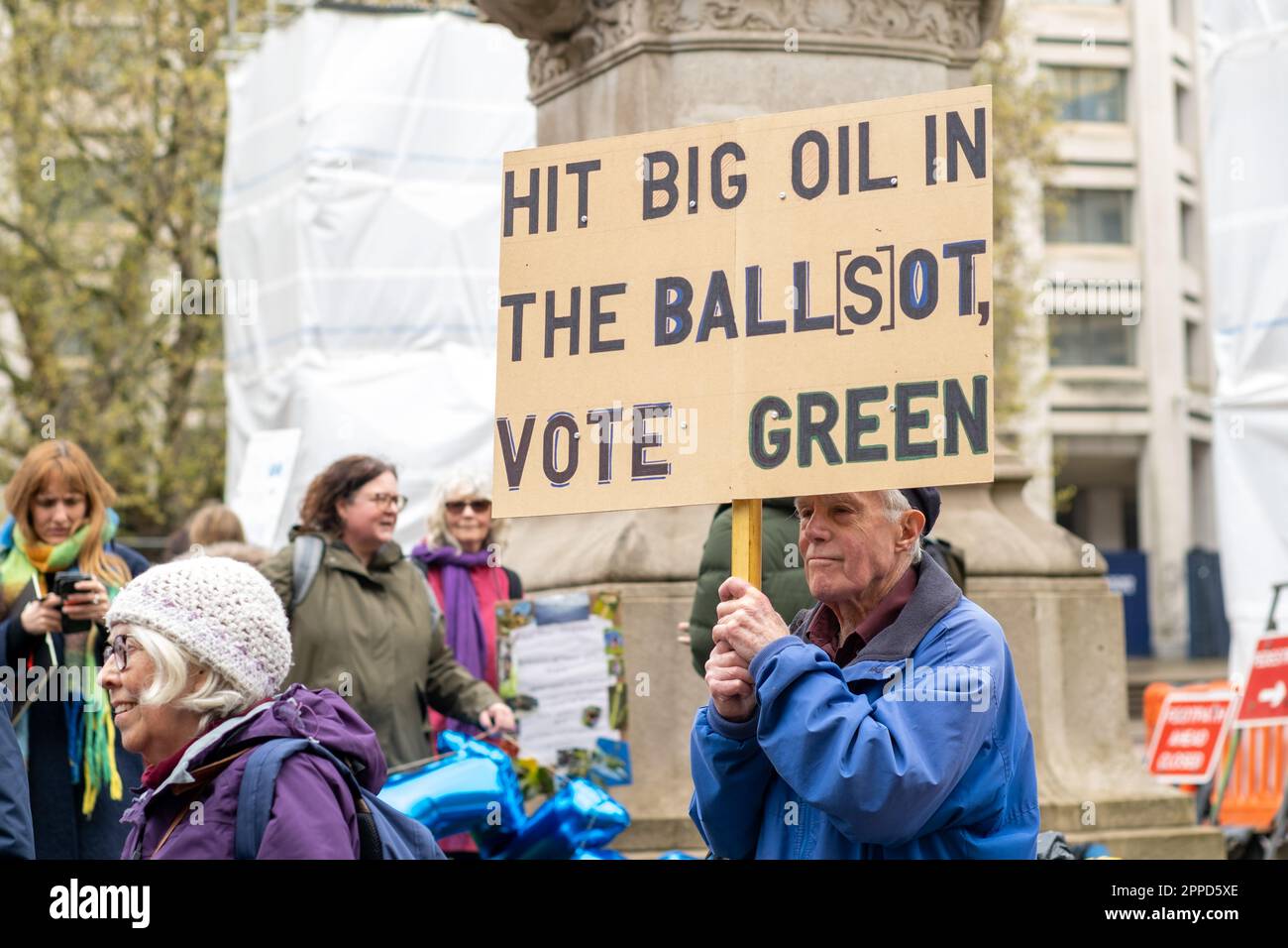 Man holds 'Vote Green' protest placard outside the department for Trade and Industry, part of the Peoples Picket, Extinction Rebellion Big One, 2023. Stock Photo