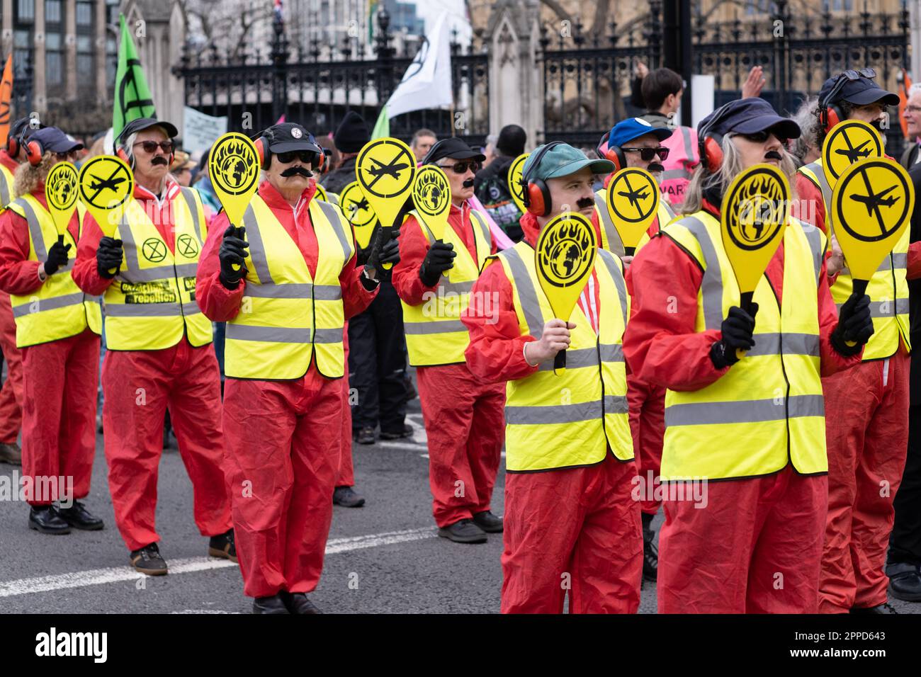 Extinction Rebellion 'mourning procession', protesters dressed as aircraft marshalls march past Parliament, part of 'The Big One' weekend, London 2023 Stock Photo