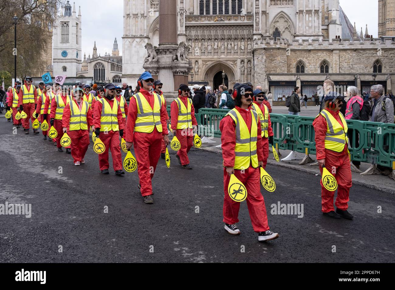Extinction Rebellion 'mourning procession', protesters dressed as aircraft marshalls march past Parliament, part of 'The Big One' weekend, London 2023 Stock Photo