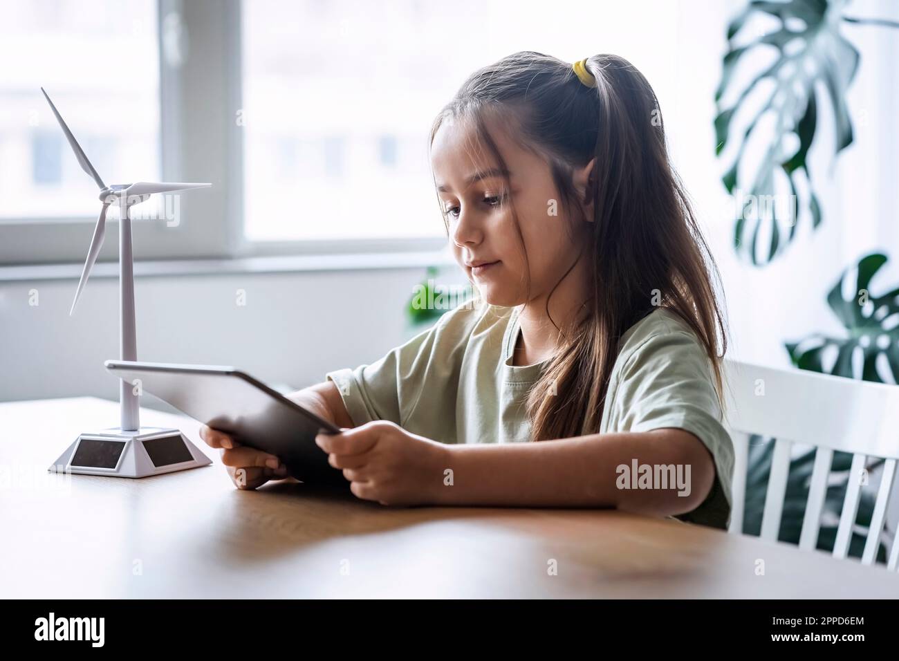 Girl using tablet PC sitting at home Stock Photo
