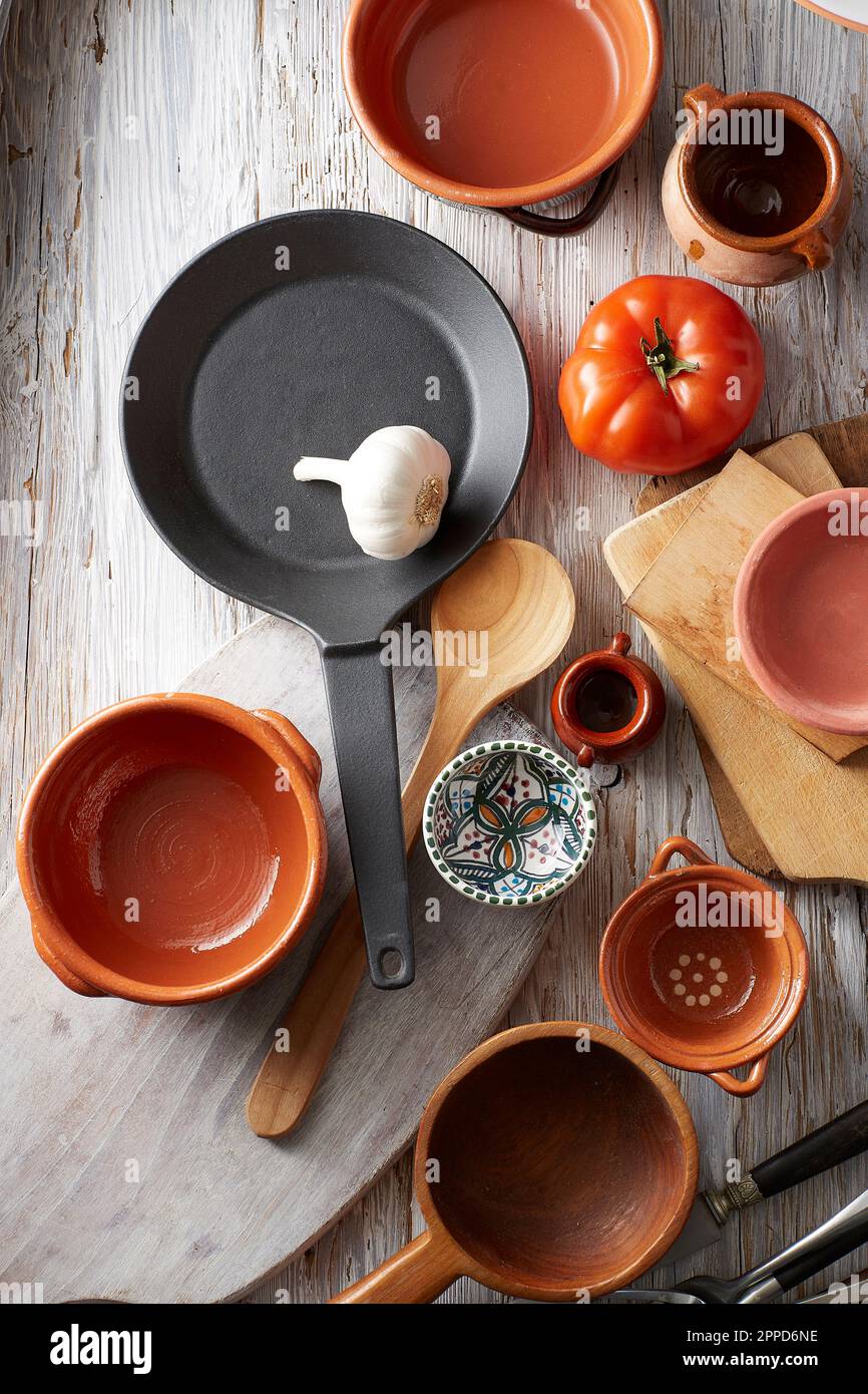 Garlic clove, red bell pepper, frying pan and empty bowls Stock Photo