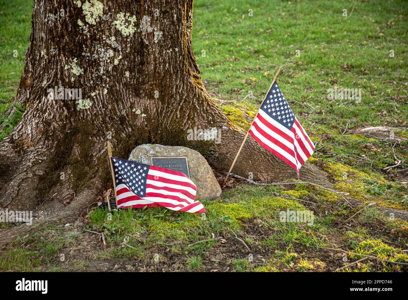 A memorial stone and flags on the Petersham, MA Town Common Stock Photo
