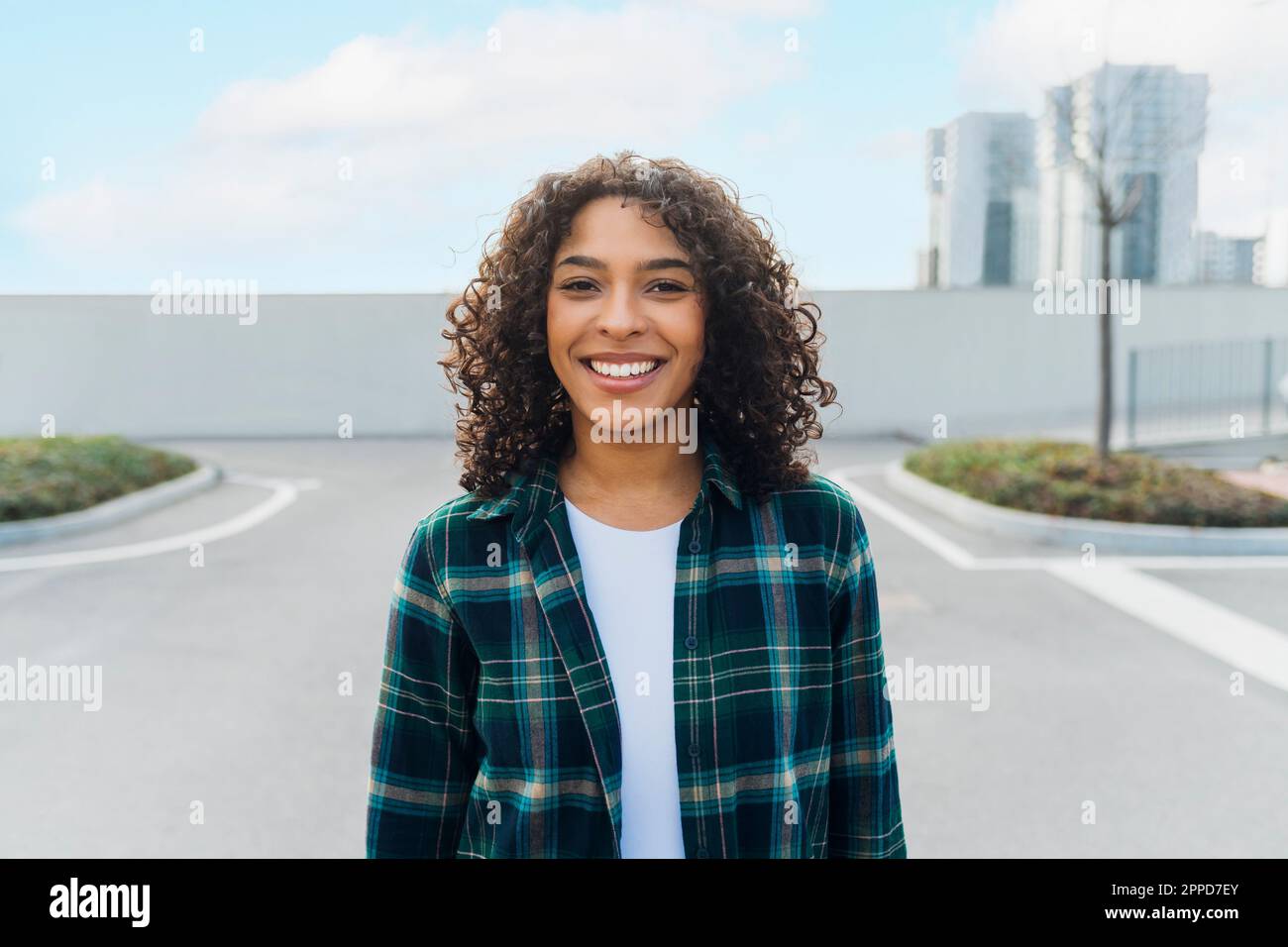 Happy curly hair young woman hi-res stock photography and images - Alamy