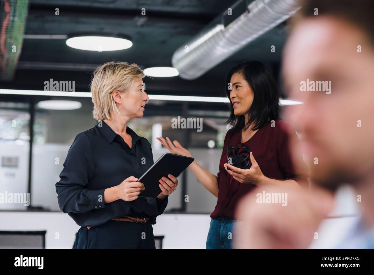 Businesswomen planning with each other at work place Stock Photo