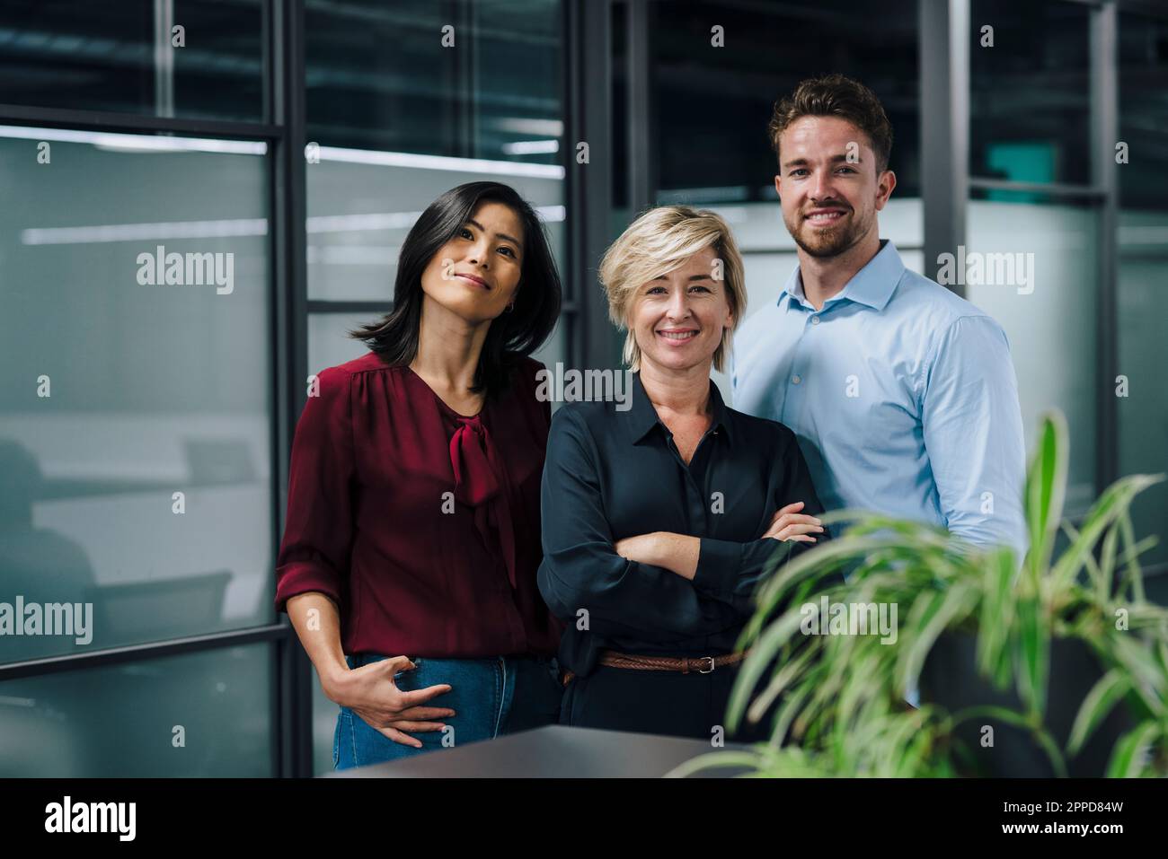Happy business people standing together in office Stock Photo - Alamy