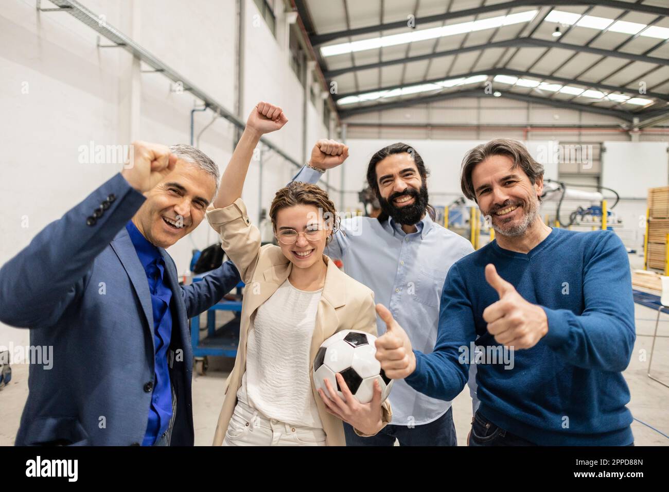 Cheerful engineers cheering together with colleague showing thumbs up ...