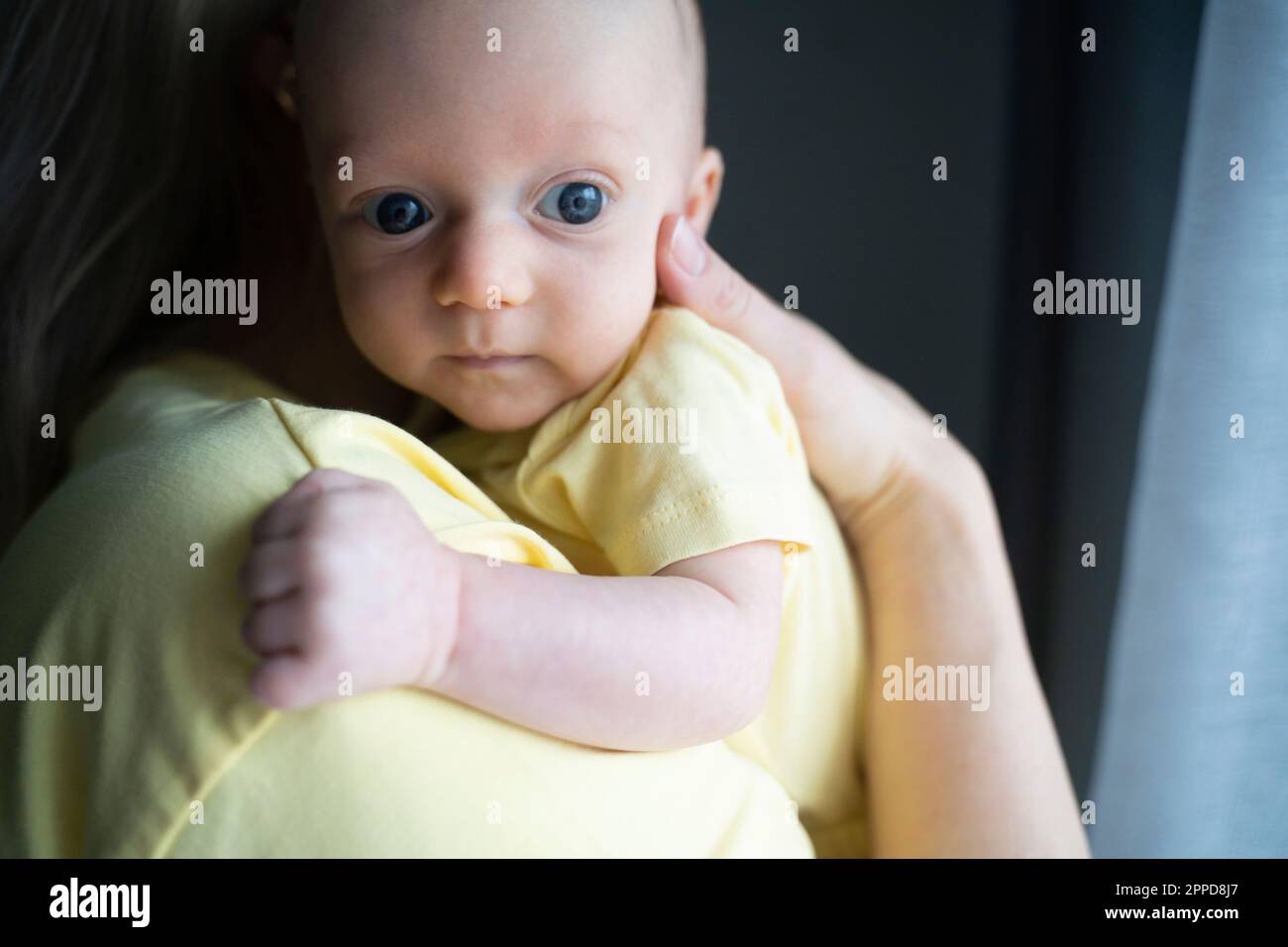 Mother carrying cute baby boy in arms Stock Photo Alamy