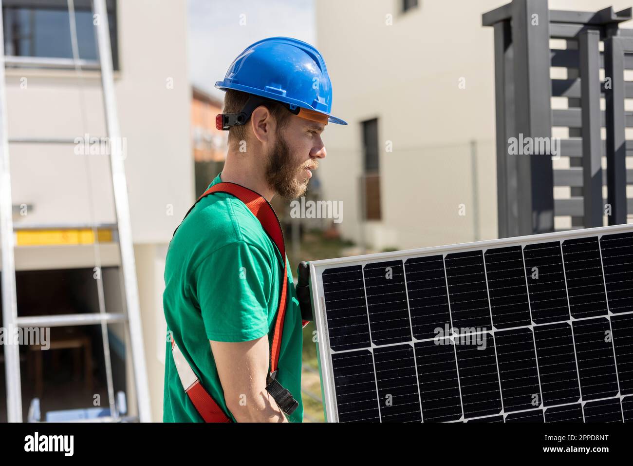 Technician holding solar panel on sunny day Stock Photo