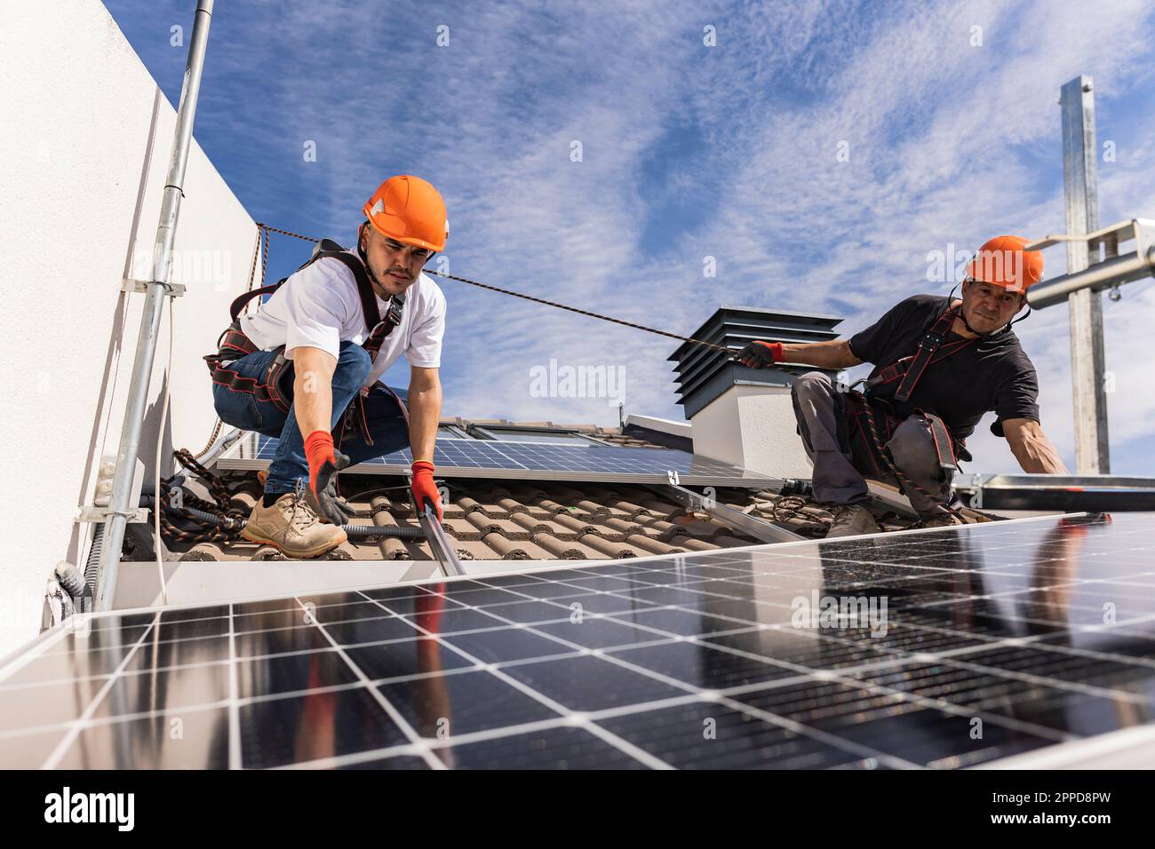 Engineers working with solar panels on rooftop Stock Photo - Alamy