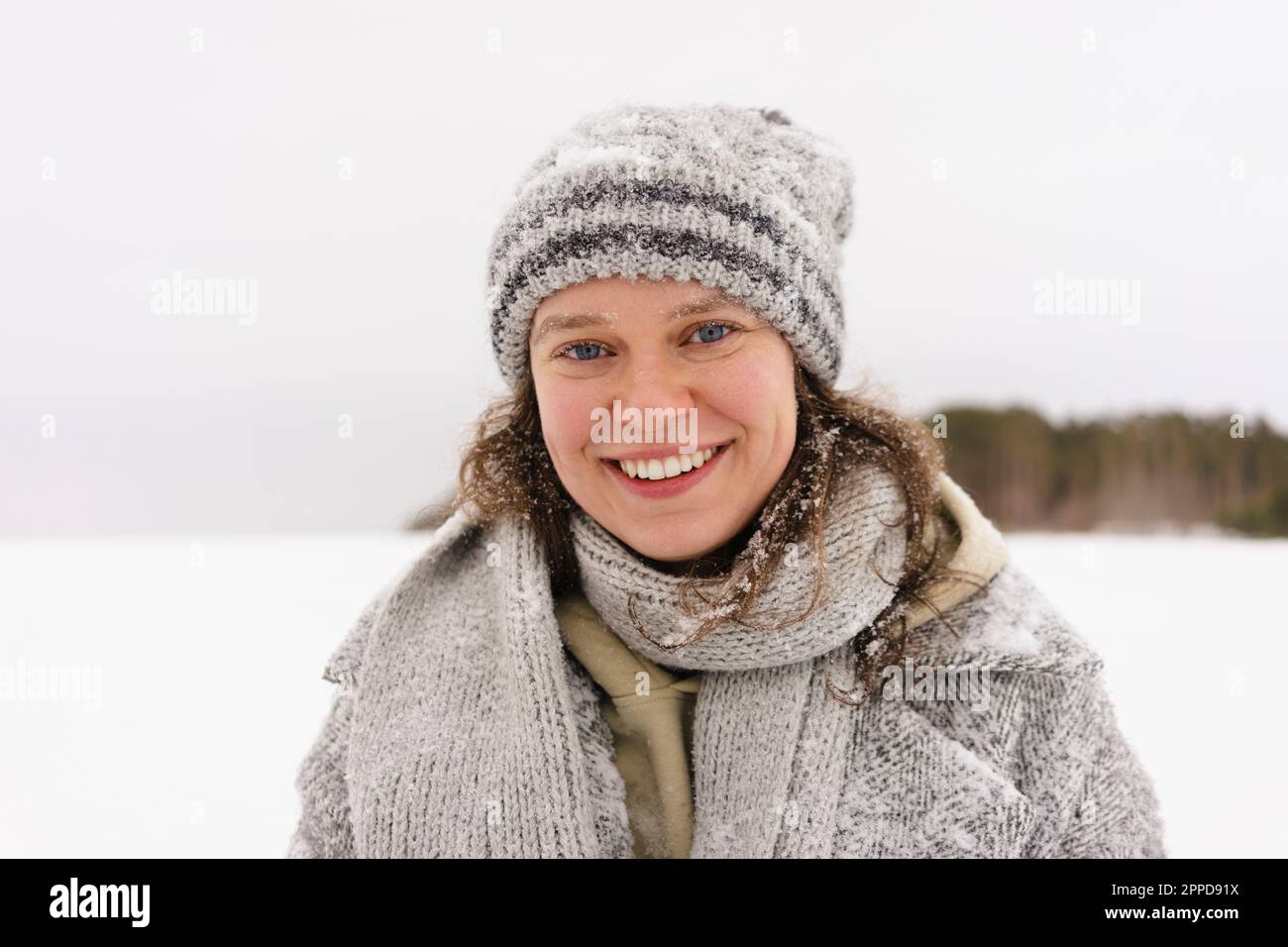Happy woman wearing knit hat in winter Stock Photo