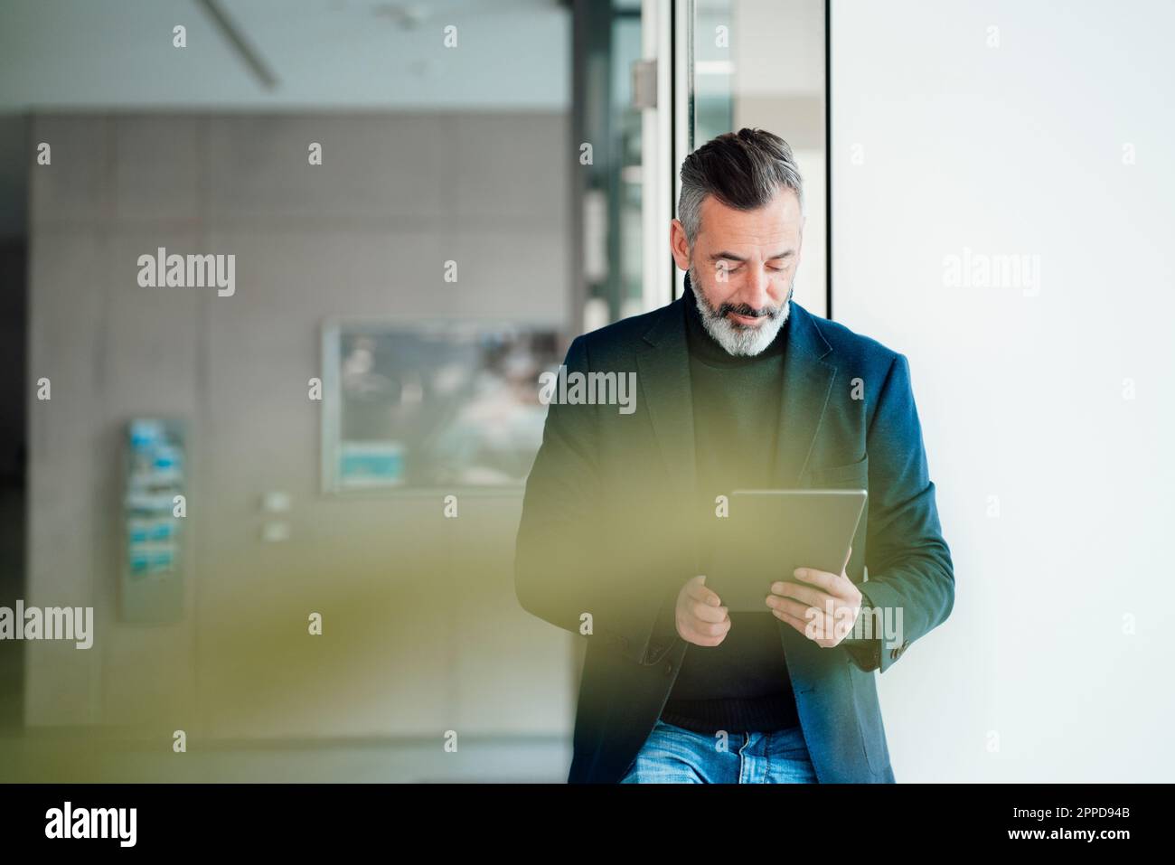 Mature businessman using tablet PC at office Stock Photo