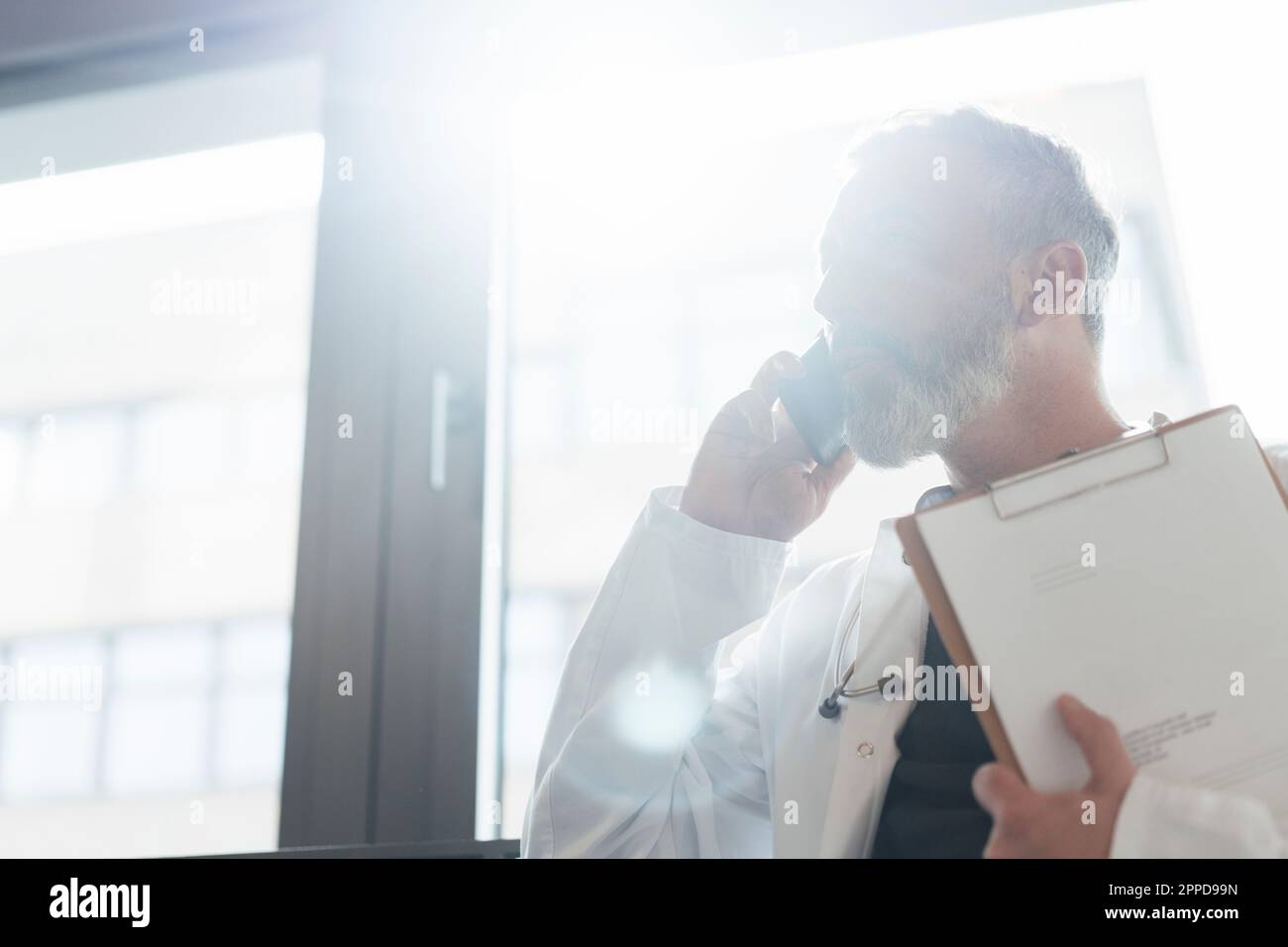 Mature male doctor talking hi-res stock photography and images - Alamy
